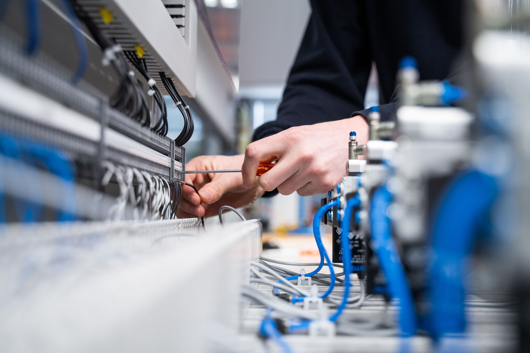 Services residential electrical services, home electrical repair, electrical installation, lighting services, electrical panel upgrades, smart home wiring, EV charger installation, electrical safety inspection Electrician working with wires and electrical components for residential services.